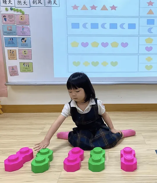 A child counting with coloured blocks