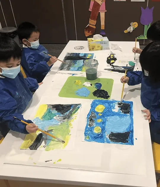 Children painting at an art table