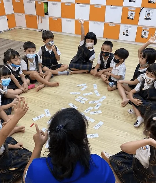 Children sitting in a circle for a shared book activity
