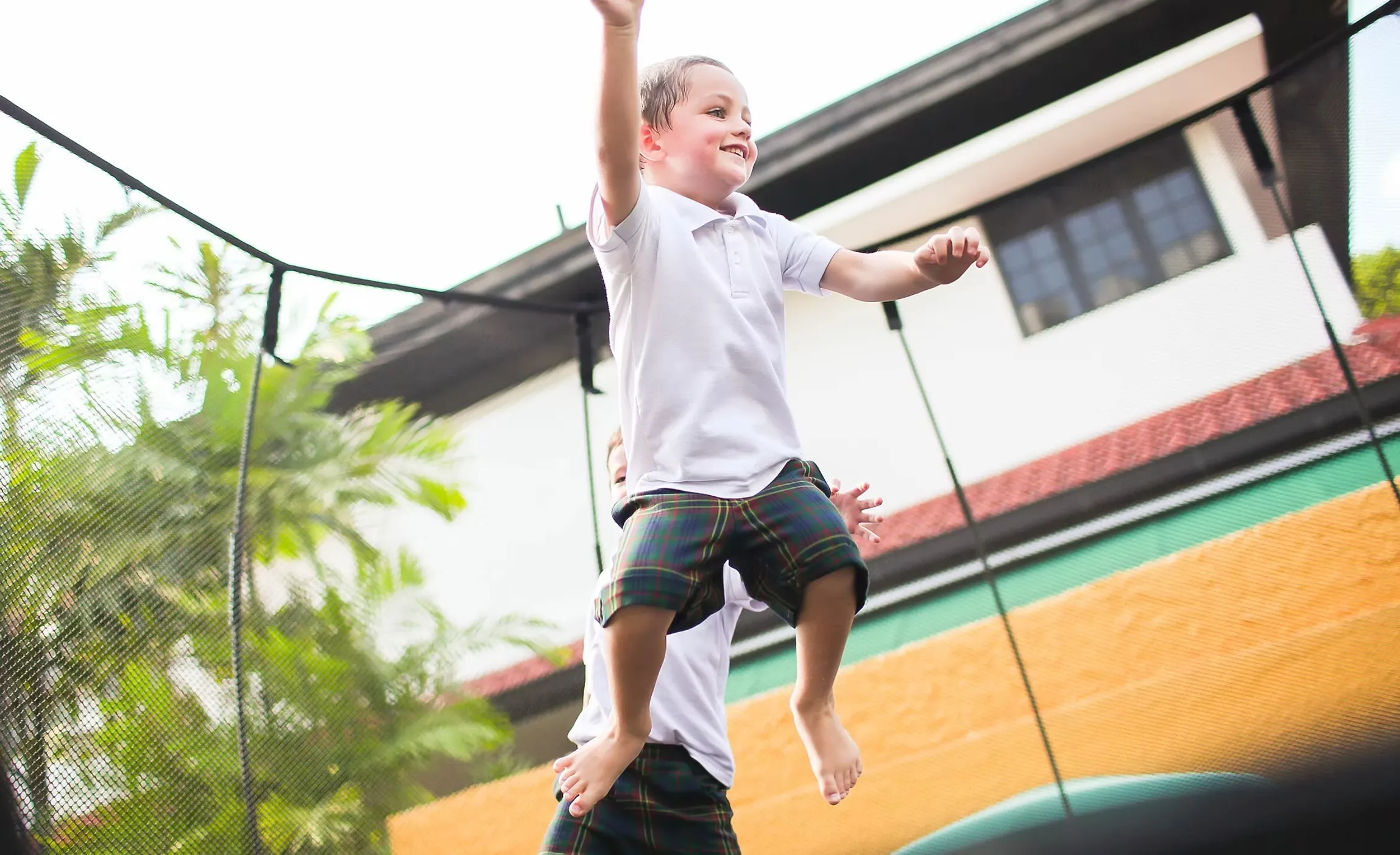 Child playing outdoors at Posso Preschool West Coast Rise