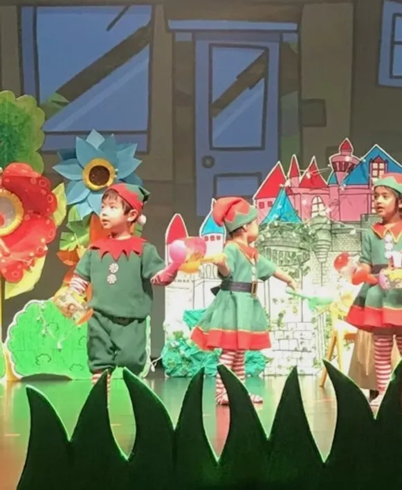 Children performing on stage in costume