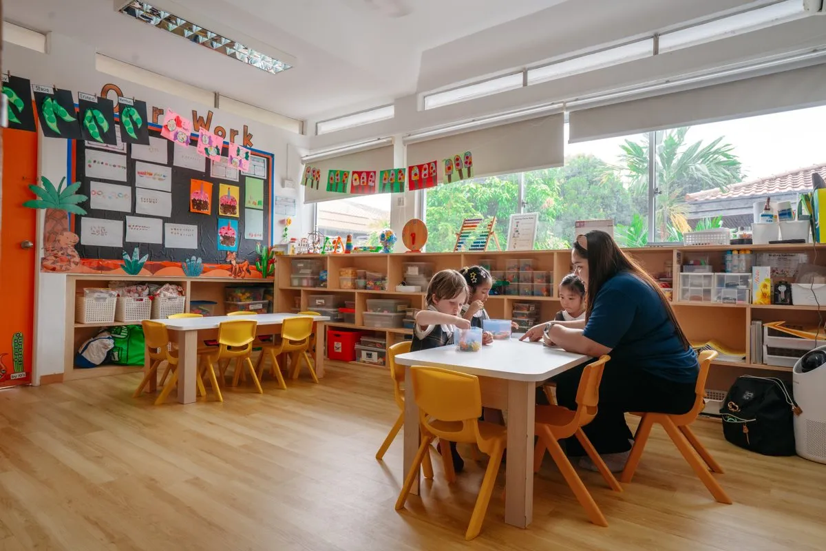 Children and a teacher in a classroom at Posso West Coast Rise