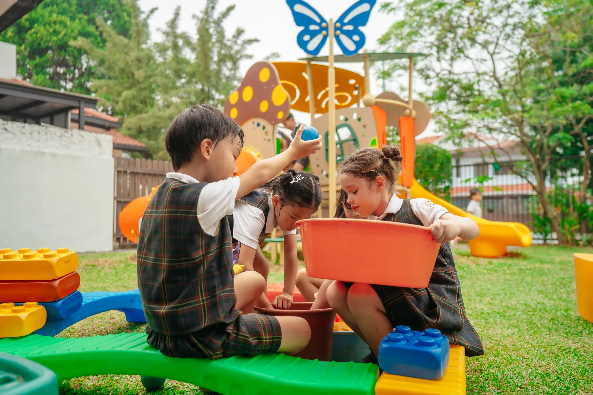 Children playing together in the garden at Posso West Coast Rise